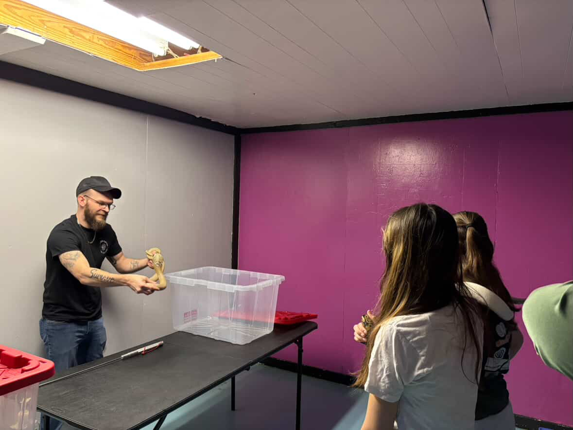 Joey demostrating Lilith the cobra.